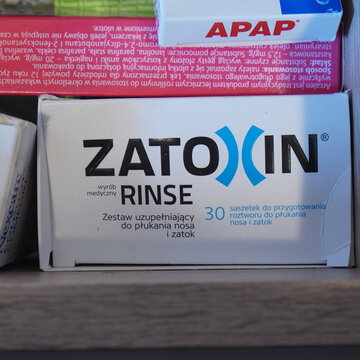 ZATOXIN RINSE nasal and sinus rinse kit on a shelf in a home medicine cabinet next to APAP pain relief medication in Warsaw, Poland