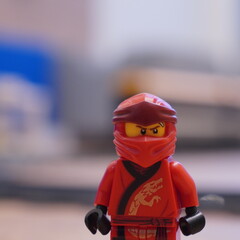 Naklejka premium Red Lego Ninja Character, a Popular Children's Toy, Depicted Up Close with a Blurred Background