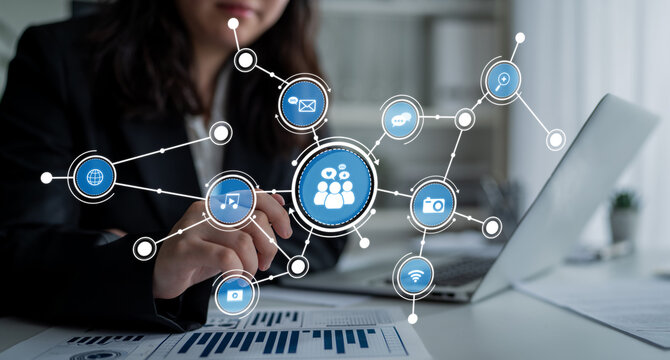 A businesswoman interacts with a laptop, showcasing a vibrant social media network concept with icons representing various communication channels and digital collaboration. Crux - Powered by Adobe