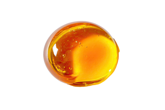 Amber, round, glossy drop of viscous liquid