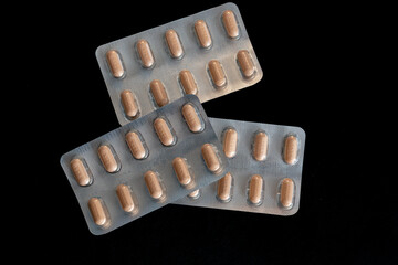 Three pills containers are stacked on top of each other