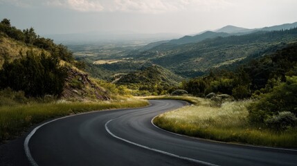 Fototapeta premium Open road through green landscape with hills in the distance, creating a serene and creative outdoor scene.