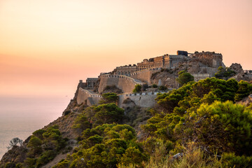 Fototapeta premium Disused military buildings on a mountain in Cabo Tiñoso in Cartagena, Region of Murcia, Spain, at dawn.