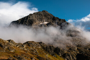The top of the mountain in the clouds in the Alps.