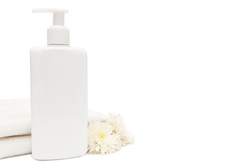 White plastic container with white towel and white flowers on white background.