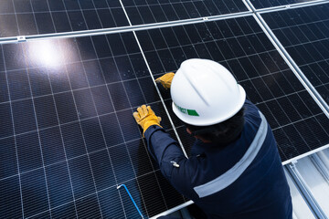 Engineer checking inspection solar cells on the roof.Technician maintaining solar panels on blue sky and white clouds background.Solar photovoltaic panel system and saving energy with clean powers.