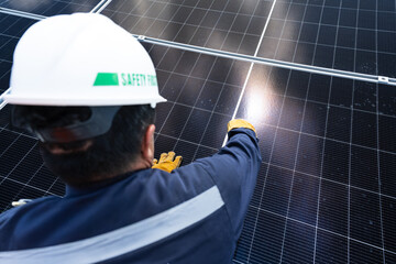 Engineer checking inspection solar cells on the roof.Technician maintaining solar panels on blue sky and white clouds background.Solar photovoltaic panel system and saving energy with clean powers.
