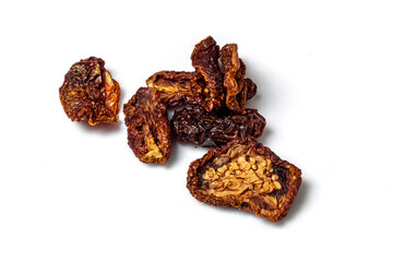 Sun dried tomato pieces showing the seeds isolated on a white cutting board