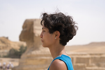 young woman in profile view in front of the sphinx, Egypt