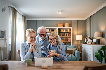 Fototapeta premium Seniors friends enjoying video call on tablet at home