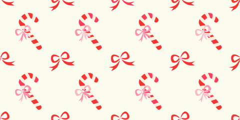 Seamless pattern of festive red and white striped candy canes with pink bows and red bows on a cream background