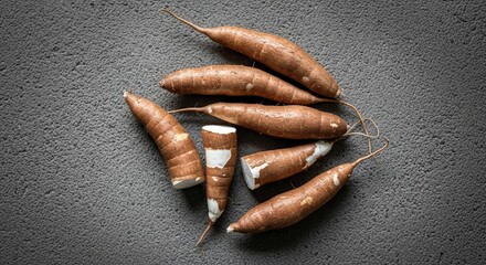 Fresh Cassava Root Vegetables on A Textured Gray Surface Close Up View