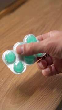 A person holding a blister pack of mint throat lozenges.
Menthol lozenges or tablets.
Sore throat relief and prevention during a sore throat.
