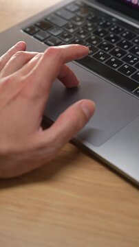 A man clicks on a laptop's touchpad with his finger.
Computer work and digital technology.
A man's finger on a computer keyboard.
Technology, device, laptop, touchpad, touchscreen, finger