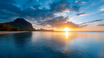 Stunning sunset over calm tropical waters with dramatic mountain silhouette and glowing sky