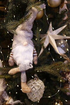 D&eacute;coration de no&euml;l dans les tons blanc avec un lutin blanc , une &eacute;toile blanche et boule de no&euml;l blanche suspendues dans un sapin