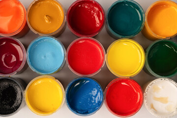 Gouache colorful paints set. Jars of gouache paint isolated on a white background.