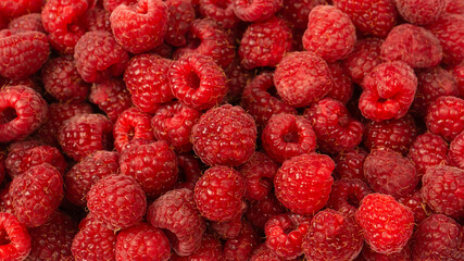 Raspberry in plastic container isolated on white background.