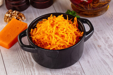 Yellow shredded cheddar cheese in the bowl