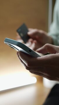 A person enters bank card information to transfer money and pay for purchases.
Financial transactions.
Monetary transactions and budget allocation.
Economics, finance, utilities, shopping