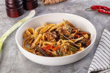 Asian cuisine udon with chicken and vegetables