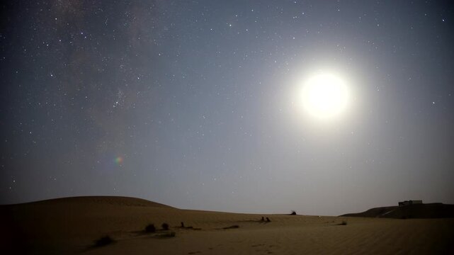 Stunning 4k timelapse of the night sky transition of moonset and Milky Way galaxy motion in the desert sand dune.  stars scape in a remote wilderness location.
