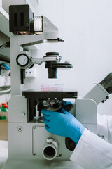 Researcher using microscope for sample analysis