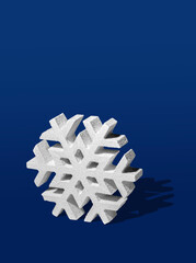 Three Dimensinoal Snowflake Ornament on a Navy Blue Background