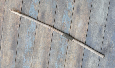 ancient wooden spear on a wooden background