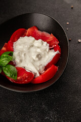 Salad strachatella and tomato portion size natural product tasty snack fresh delicious gourmet food background on the table rustic top view copy space keto and paleo diet