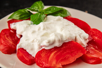 Salad strachatella and tomato portion size natural product tasty snack fresh delicious gourmet food background on the table rustic top view copy space keto and paleo diet