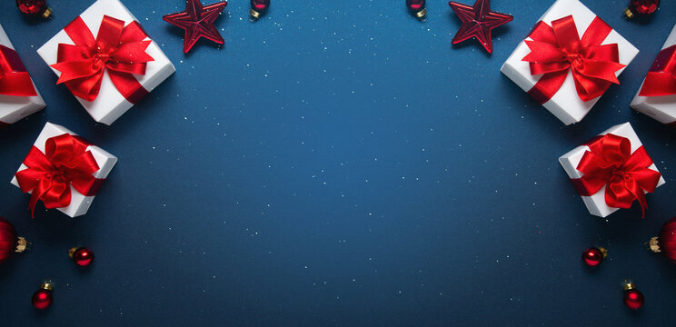 Merry Christmas and Happy Holidays greeting card, frame, banner. New Year. Noel. Red and white Christmas decorations and gifts on blue background top view. Winter xmas holiday celebration theme. - Powered by Adobe