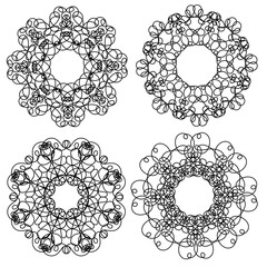 Set of four hand-drawn black circular abstract patterns on a white background in a linear style