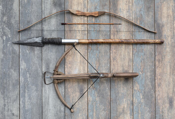 ancient wooden crossbow and bow on wooden background
