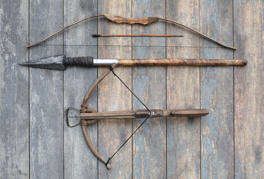 ancient wooden crossbow and bow on wooden background