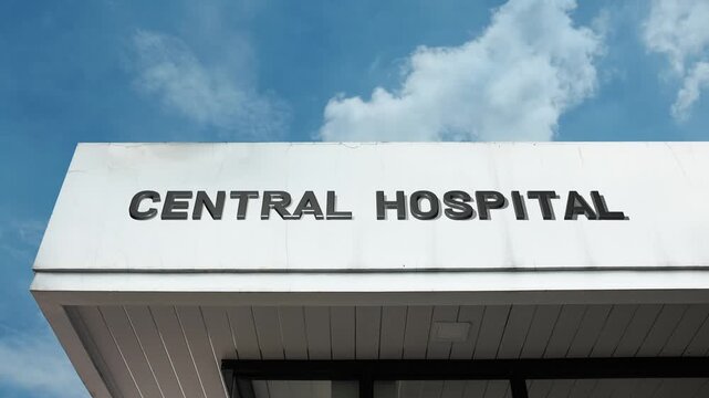 Central Hospital word sign prominently displayed on the large, institutional facade of a major medical center beneath a clear blue sky, signifying a primary healthcare facility serving a wide region o