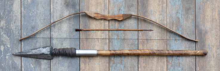 ancient wooden bow on a wooden background