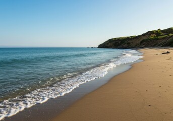 Obraz premium Gentle waves kiss the sandy expanse, revealing a peaceful meeting point where the vast ocean patiently greets the sturdy coastal landmass ,land ,vast ,marine