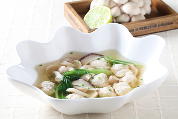 A Korean-style soup made with willow milky mushrooms, squid meatballs, and vegetables in a light clear broth for a savory and gentle flavor. Created by Master Chef Hanshunseop. Photographed in Korea.