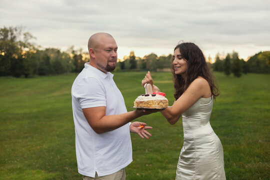 A happy couple and a cake. Celebrating an anniversary.