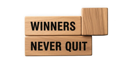 Wooden blocks spell out winners never quit motivational message