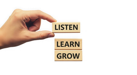 Hand holding wooden blocks with listen learn grow words