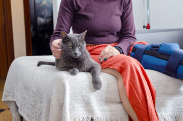 Woman with a broken leg with her cat.