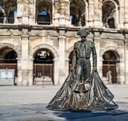 N&icirc;mes, Provence, France &ndash; Exterior of the Arena of N&icirc;mes with the statue of a bullfighter (torero).