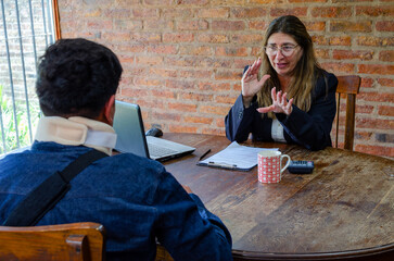 Smiling mature adult female lawyer assist a injured man with legal problem. Lawyer showing document. Compensation for work or car accident. Legal concept. Social Worker.