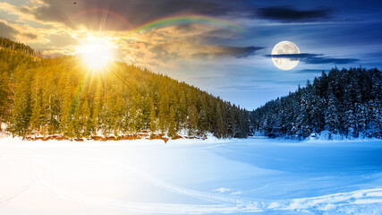 winter landscape with snow covered ground. day and night time change concept. frozen lake among spruce forest with sun and moon. panoramic view of winter wonderland. duality and transition template