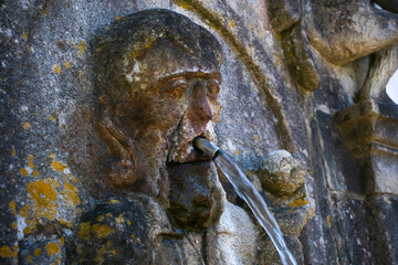 Close-up of the Taste Fountain at Bom Jesus do Monte stairway in Braga Portugal Water flows from the figures mouth symbolizing the sense of taste and spiritual purification