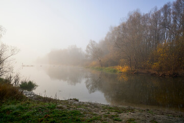 Foggy dawn in autumn by the river.