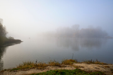 Foggy dawn in autumn by the river.