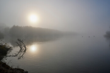 Foggy dawn in autumn by the river.
